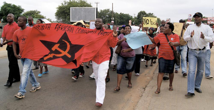 Protestors run after police van to get at theft accused that ravaged township