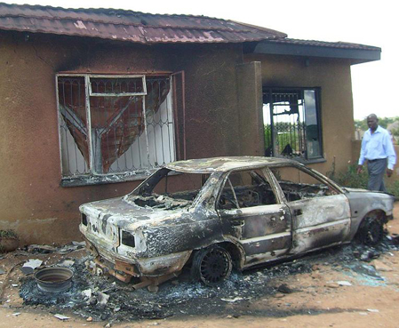 Two houses and vehicle set alight