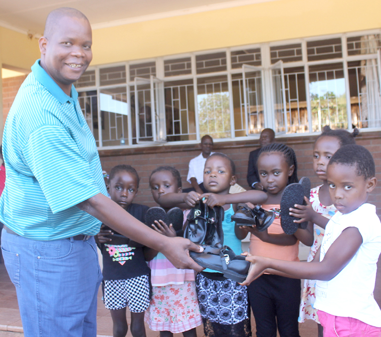 King Toni presents school shoes to disadvantaged