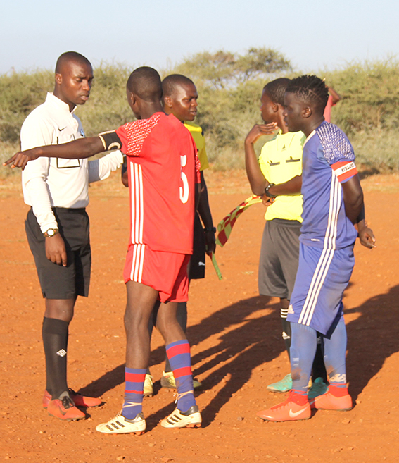 Players walk off the field in MMK league match