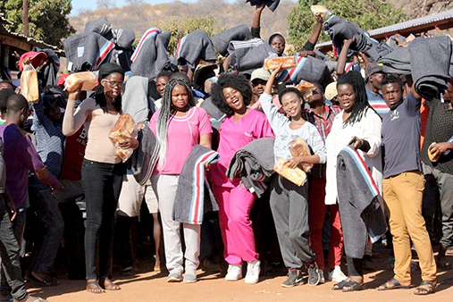 Young radiographer presents blankets to refugees