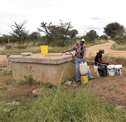Residents risking their lives to get water from manholes