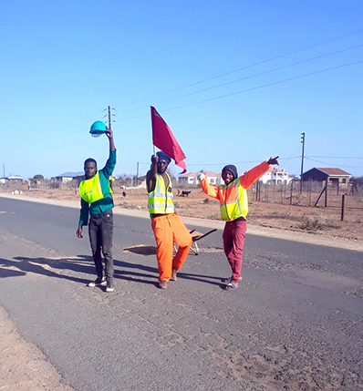 Young volunteers start to fill potholes to make roads safer