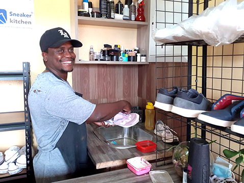 Lutendo makes money by washing shoes