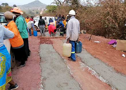 Villagers opt to fix road and not wait in vain